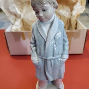 Lladro Retired Figurine titled "Boy With Robe" In